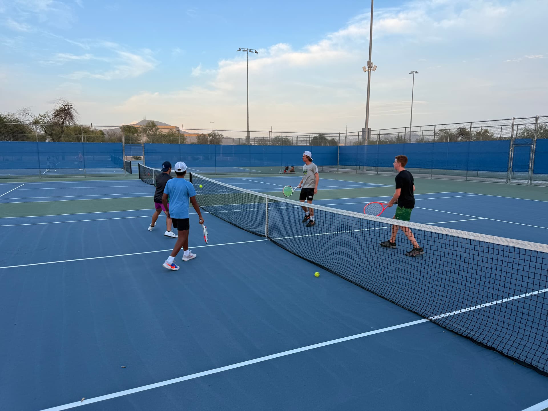 Man playing tennis at an academy